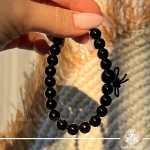 Power Crystal Bracelet - Black Onyx The stunning Black Onyx Power Bracelet adorned with a Tibetan knot and a guru bead. Perfect for energy balance and style. Available at GAIA CENTER in Cyprus for in-store and online orders.