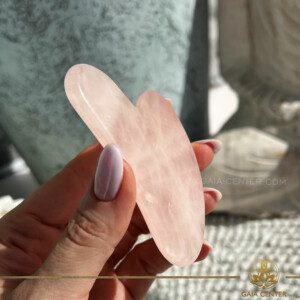Gua Sha Massage Stone Rose Quartz crystals at Gaia Center Crystal shop in Cyprus. The Guasha Massage Stone is specifically crafted to harness these properties, aiding in the release of tension, improvement of circulation, and promotion of lymphatic drainage. This ancient tool is also known for its ability to stimulate the skin, reduce puffiness, and enhance the natural glow of your complexion. Order online, Cyprus islandwide delivery: Limassol, Larnaca, Paphos, Nicosia. Europe and Worldwide shipping.