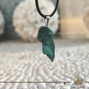Malachite Crystal Pendant - Rough Style |Zaire| at Gaia Center Crystal shop in Cyprus. The Malachite crystal pendant symbolizes not just a piece of jewelry but also ancient wisdom and spiritual awakening. When worn as a pendant, Malachite is said to create a protective shield around the wearer, shielding them from negative energies and promoting emotional balance and inner harmony. Its vibrant green color is often associated with the heart chakra, making it an ideal crystal for promoting love, compassion, and healing in matters of the heart. Order crystals online, Cyprus islandwide delivery: Limassol, Larnaca, Paphos, Nicosia. Europe and Worldwide shipping.