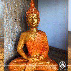 Buddha Statue sitting gold and orange color. Spiritual items at Gaia Center in Cyprus. Cyprus and International Shipping.