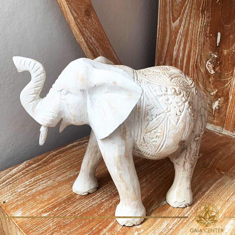 Elephant statue wooden hand carved white wash and gold colors. Decore and spiritual items at Gaia Center in Cyprus. Shop online at https://gaia-center.com. Cyprus and Worldwide shipping.