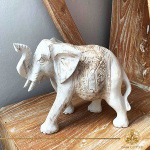 Elephant statue wooden hand carved white wash and gold colors. Decore and spiritual items at Gaia Center in Cyprus. Shop online at https://gaia-center.com. Cyprus and Worldwide shipping.