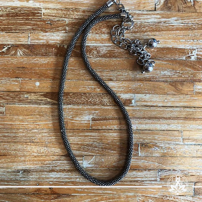 Summer necklace - silver color beads on a long string with metal balls charms. Summer essential jewellery at Gaia Center in Cyprus. Shop online at https://gaia-center.com. Cyprus and Worldwide shipping.