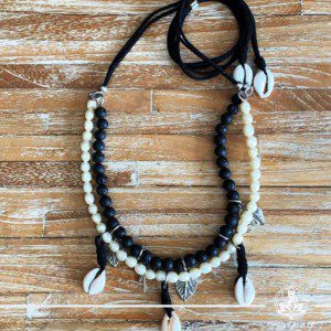 Summer necklace - black lava stone with white pearls imitation with sea shells charms on a string. Summer essential jewellery at Gaia Center in Cyprus. Shop online at https://gaia-center.com. Cyprus and Worldwide shipping.