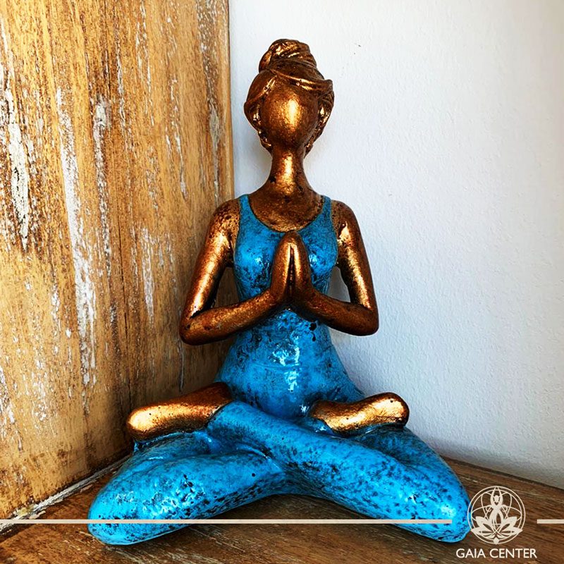 Yoga Lady Meditating Statue - Lotus pose and Hands in Namaste- casted lava sand with antique gold and blue color finishing. Spiritual items at Gaia Center in Cyprus. Order online: https://www.gaia-center.com Cyprus and International Shipping.