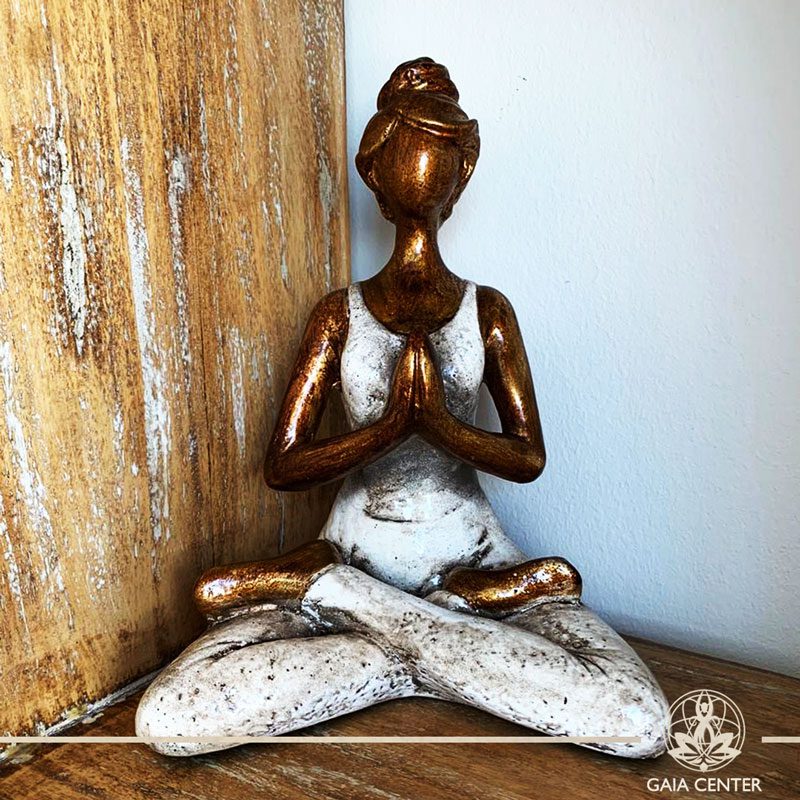 Yoga Lady Meditating Statue - Lotus pose and Hands in Namaste- casted lava sand with antique gold and white color finishing. Spiritual items at Gaia Center in Cyprus. Order online: https://www.gaia-center.com Cyprus and International Shipping.