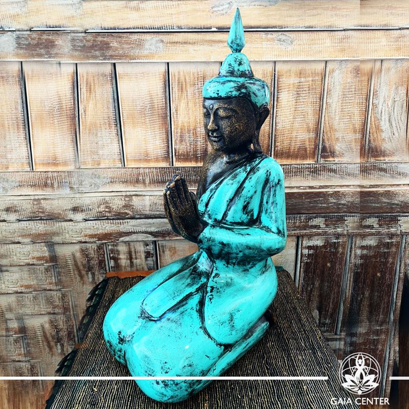 Buddha Statue turquoise and antique gold finishing sitting and meditating with hands gesturing NAMASTE at Gaia Center in Cyprus. Shop online at https://gaia-center.com. Cyprus and Worldwide shipping.