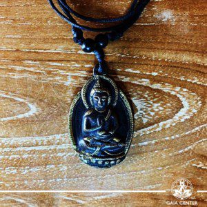 Tibetan Pendant meditating Buddha. Made from metal with engraved design, on an adjustable black string. Tibet Selection of Tibetan Jewelry made from crystals, gemstones, combination of metals at Gaia Center | Cyprus.