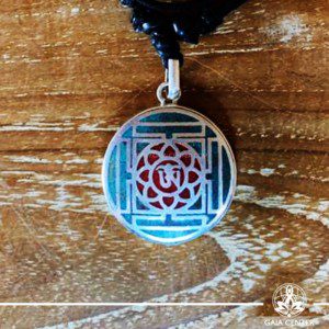 Tibetan Pendant Om symbol in lotus flower and yantra or mandala design. Red coral and turquoise. Adjustable black string. Selection of Tibetan Jewelry made of crystals, gemstones, combination of metals at Gaia Center | Cyprus.