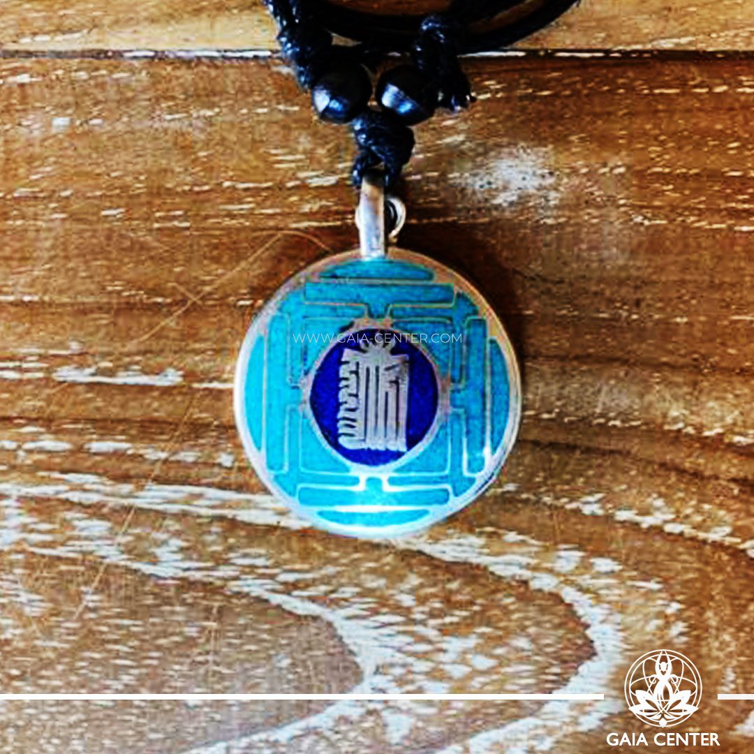 Tibetan Pendant Kalachakra buddhist symbol and mandala or yantra design. Metal inlaid with turquoise, lapis lazuli. Adjustable black string. Selection of Tibetan Jewelry made from crystals, gemstones, combination of metals at Gaia Center | Cyprus.