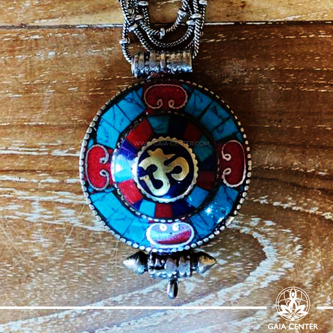Tibetan gau pendant amulet box selection with semiprecious stones. Tibetan Pendant inlaid with turquoise, coral and lapis lazuli. Om symbol. Long chain. Selection of Tibetan Jewelry made from crystals, gemstones at Gaia Center | Cyprus.