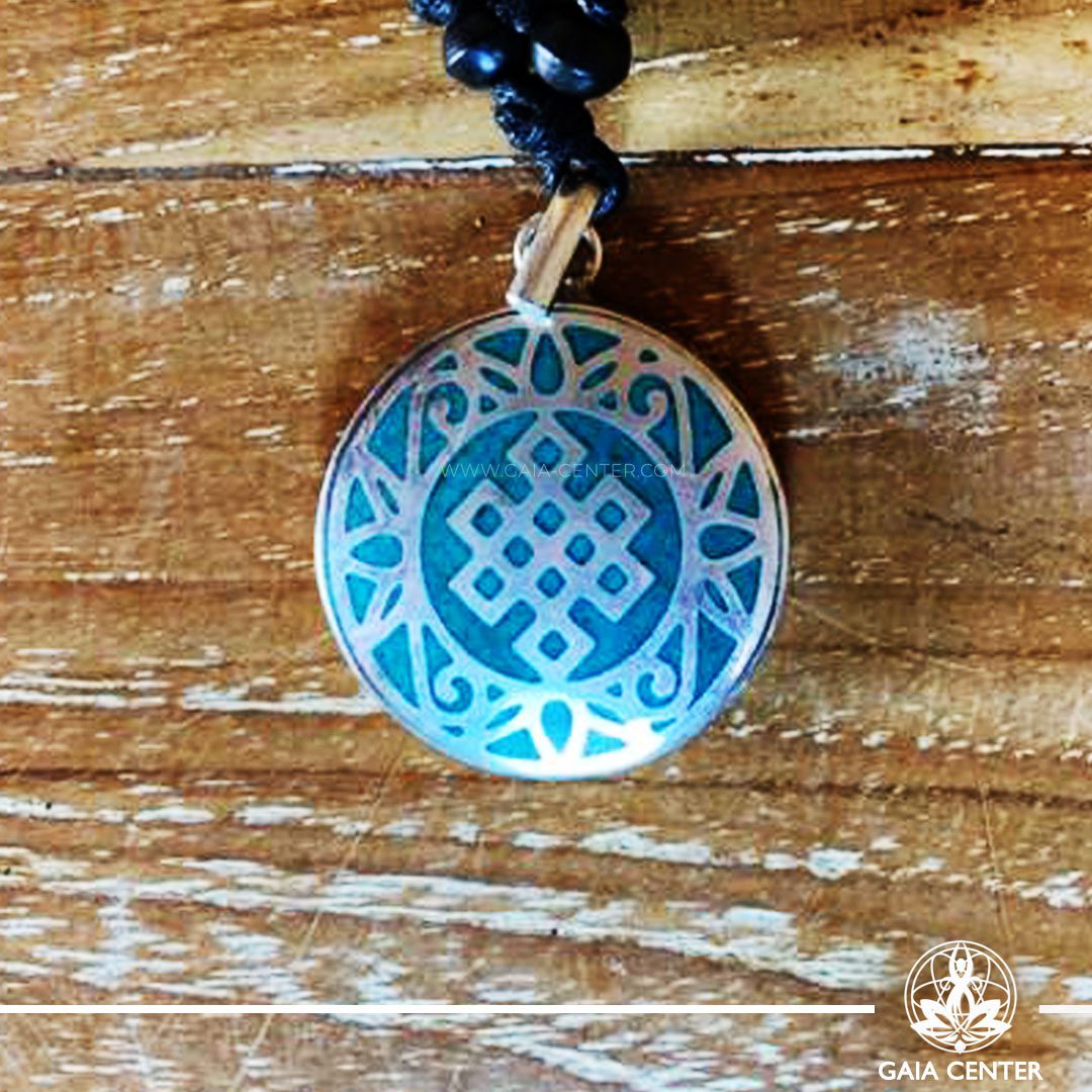Crystal Pendant and Semiprecious Gemstone. Tibetan Pendant Endless knot buddhist symbol inlaid with crystal stone - crushed turquoise. Adjustable black string. Selection of Tibetan Jewelry made from crystals, gemstones, combination of metals at Gaia Center | Cyprus.