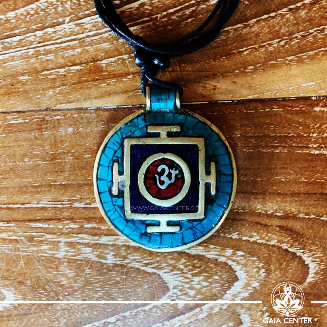 Tibetan Pendant Om symbol and yantra or mandala design. Red coral, lapis lazuli and turquoise. Adjustable black string. Selection of Tibetan Jewelry made of crystals, gemstones, combination of metals at Gaia Center | Cyprus.