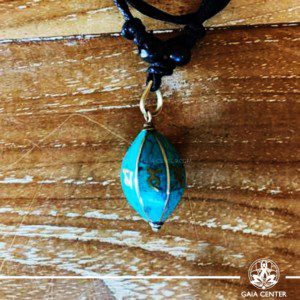 Tibetan Pendant Turquoise Drop Style design. Made from combination of metals and semiprecious stone. Adjustable black cord or string. Selection of Tibetan jewelry at Gaia Center.