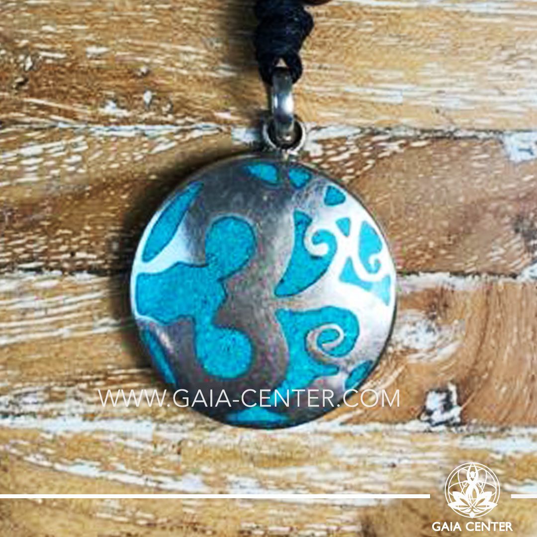 Crystal Tibetan Pendant with om symbol. Metal inlaid with semiprecious gemstones. Adjustable black string. Selection of Tibetan Jewelry made from crystals, gemstones, combination of metals at Gaia Center | Cyprus.