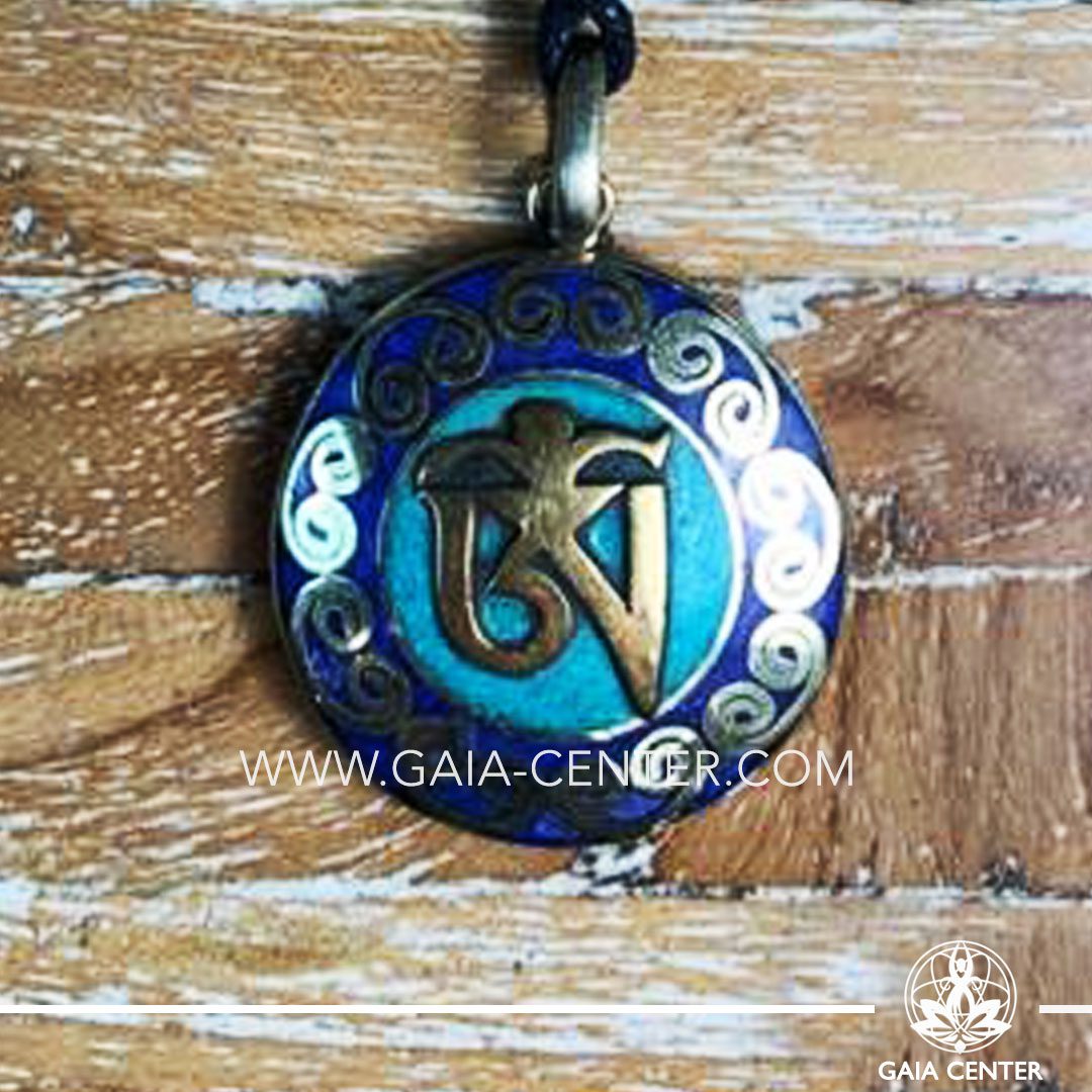 Tibetan Pendant with om symbol. Metal inlaid with semiprecious gemstones. Adjustable black string. Selection of Tibetan Jewelry made from crystals, gemstones, combination of metals at Gaia Center | Cyprus.
