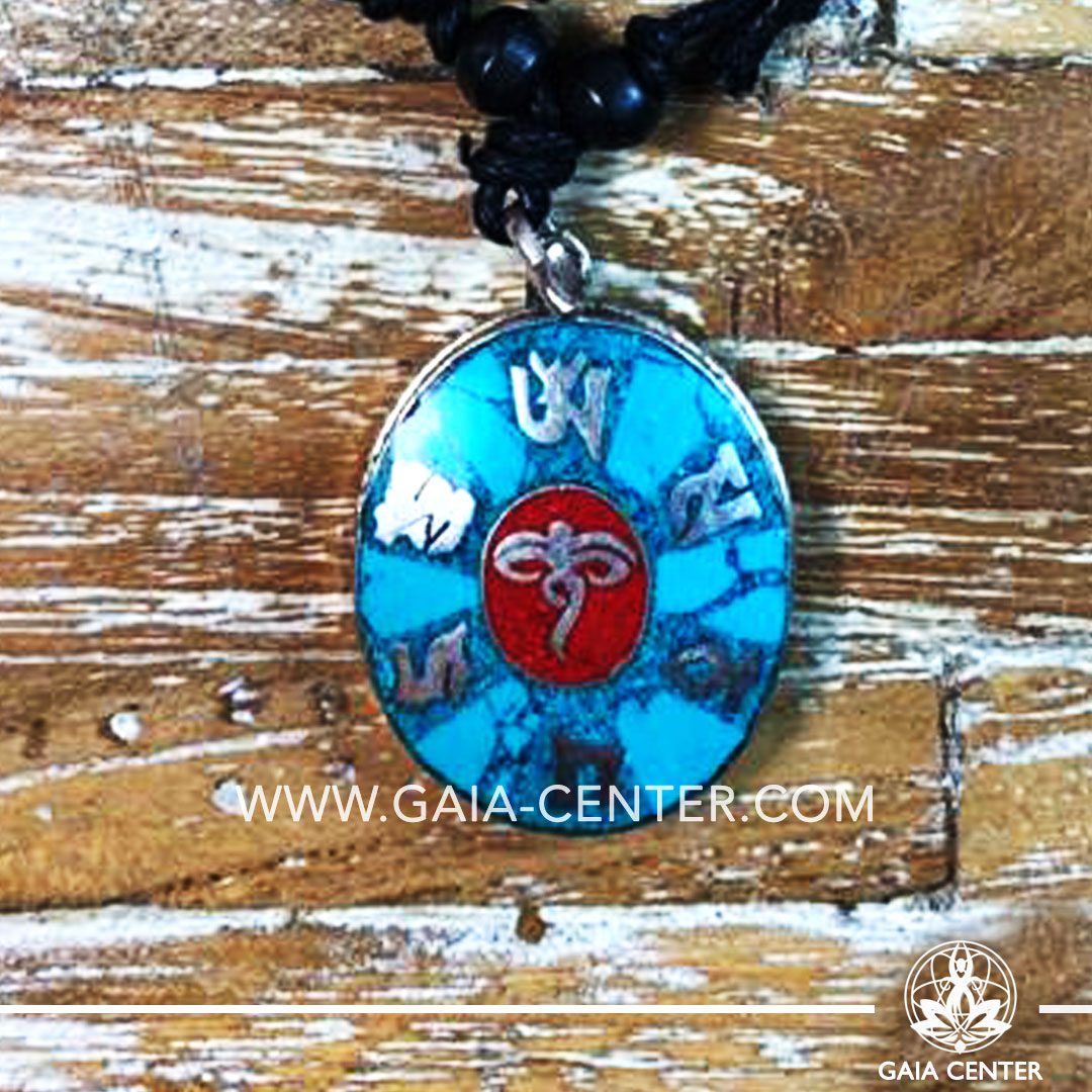 Tibetan Pendant turquoise and red color. Made from metal with engraved buddhist design, buddha eyes on an adjustable black string. Tibet Selection of Tibetan Jewelry made from crystals, gemstones, combination of metals at Gaia Center | Cyprus.