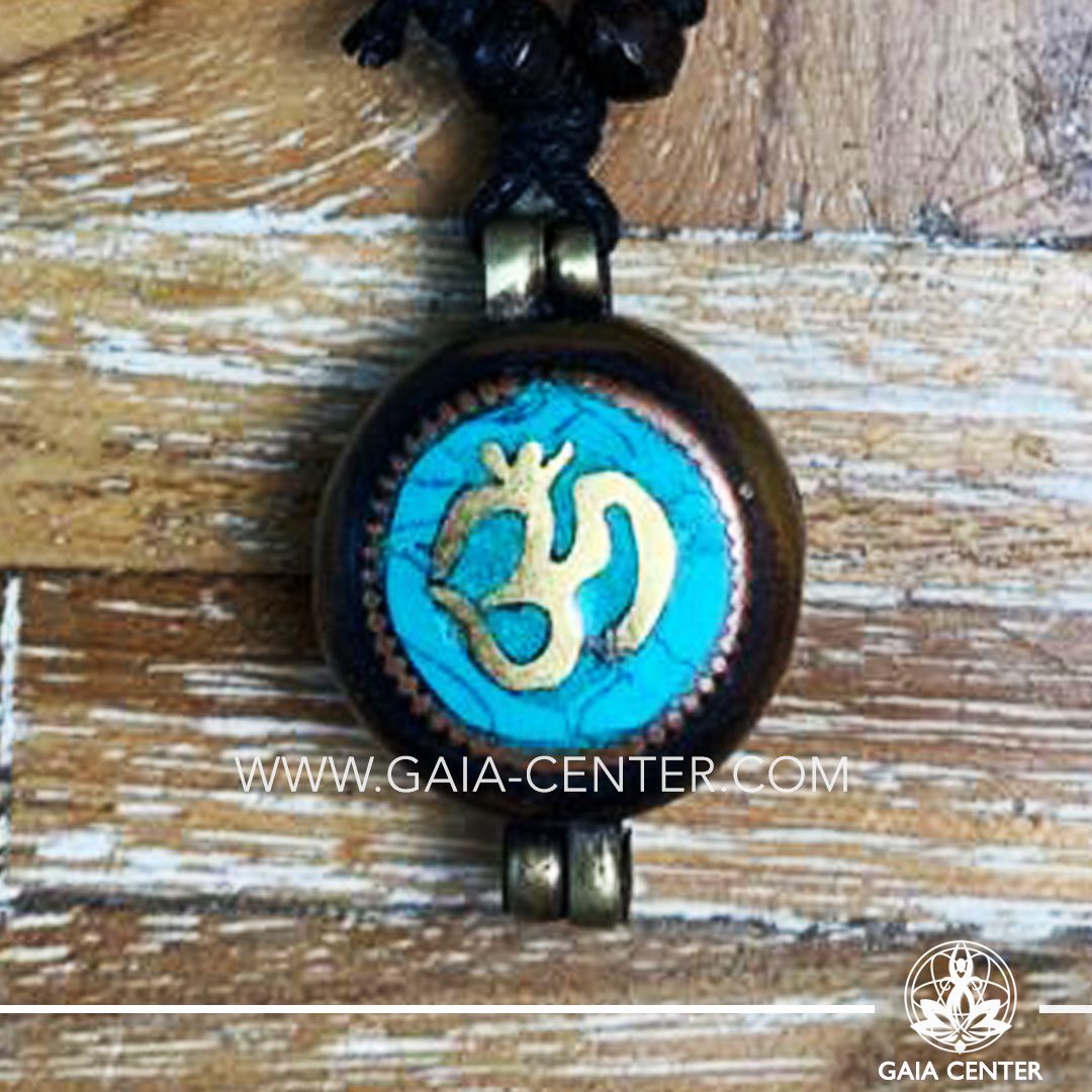 Tibetan Pendant Gau box amulet with Om symbol. Metal inlaid with semiprecious gemstones. Adjustable black string. Selection of Tibetan Jewelry made from crystals, gemstones, combination of metals at Gaia Center | Cyprus.