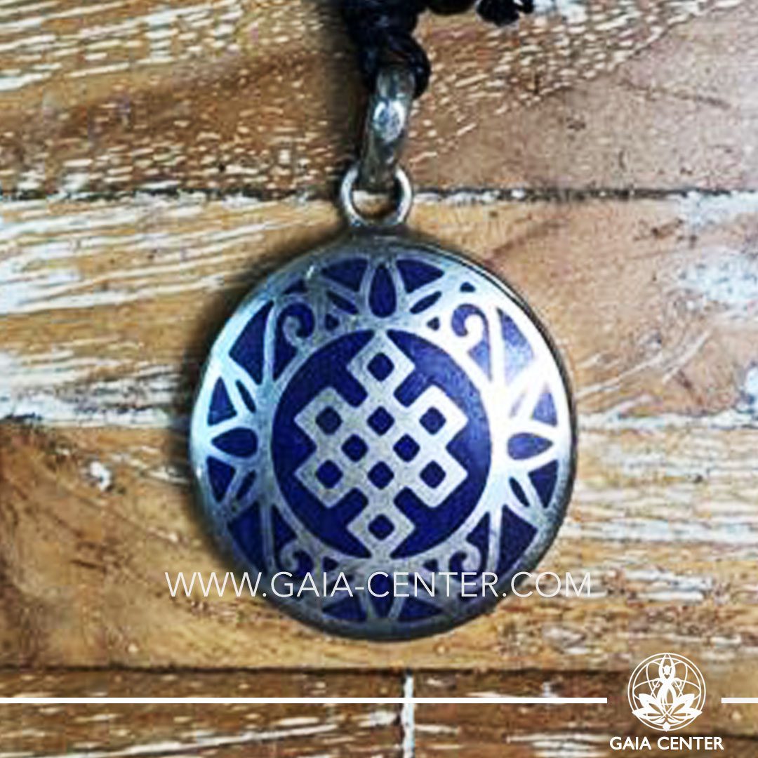 Crystal Pendant and Semiprecious Gemstone. Tibetan Pendant Endless knot buddhist symbol inlaid with crystal stone -crushed lapis lazuli. Adjustable black string. Selection of Tibetan Jewelry made from crystals, gemstones, combination of metals at Gaia Center | Cyprus.