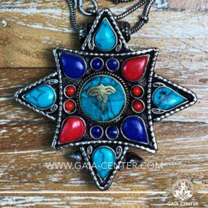Crystal and Semiprecious Gemstone Pendant. Tibetan Pendant Gau box amulet with Buddha wisdom eyes symbol. Metal inlaid with semiprecious gemstones. Adjustable black string. Selection of Tibetan Jewelry made from crystals, gemstones, combination of metals at Gaia Center | Cyprus.