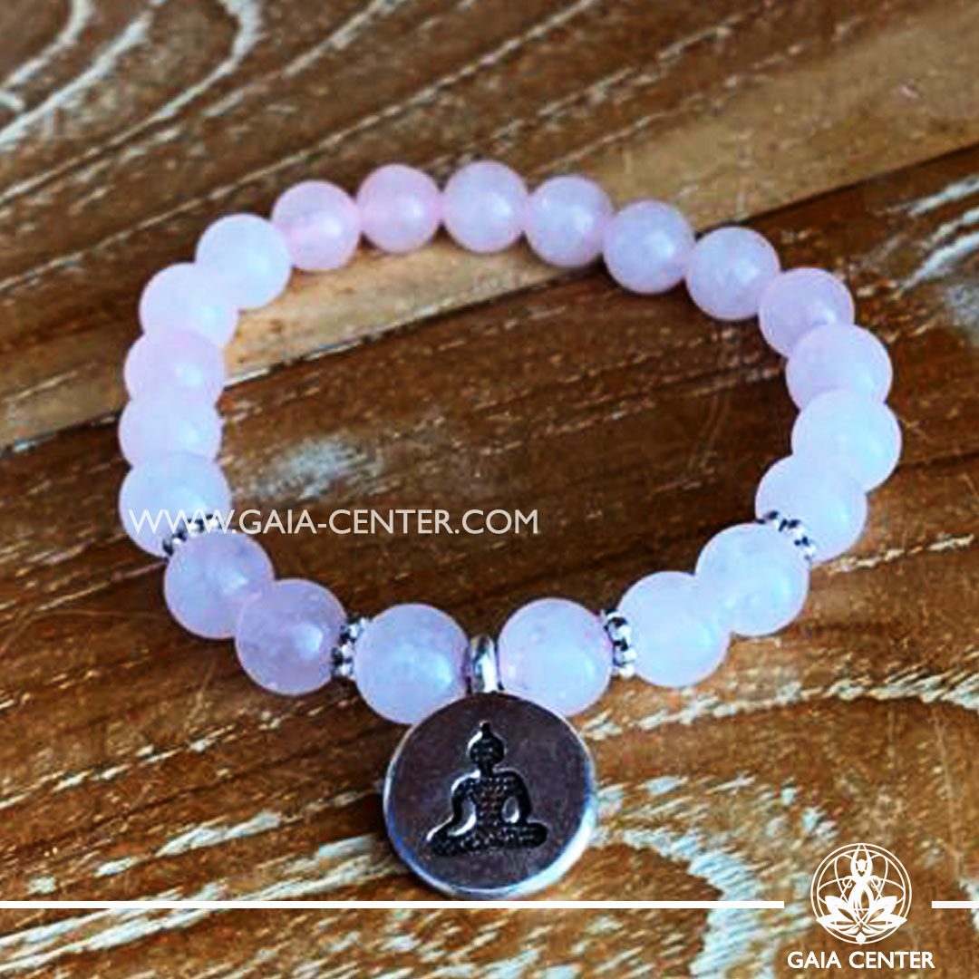 Crystal Mala Bracelet - 21 Rose quartz crystal beads with Buddha symbol metal charm. Elastic string. Crystal and Gemstone Jewellery Selection at Gaia Center in Cyprus.