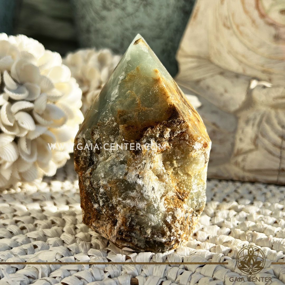 Crystal Green Onyx Quartz Rough Cut Base Polished Point from Brazil. Crystal points, towers and obelisks selection at GAIA CENTER Crystal Shop in CYPRUS. Order online, Cyprus islandwide delivery: Limassol, Larnaca, Paphos, Nicosia. Europe and Worldwide shipping.