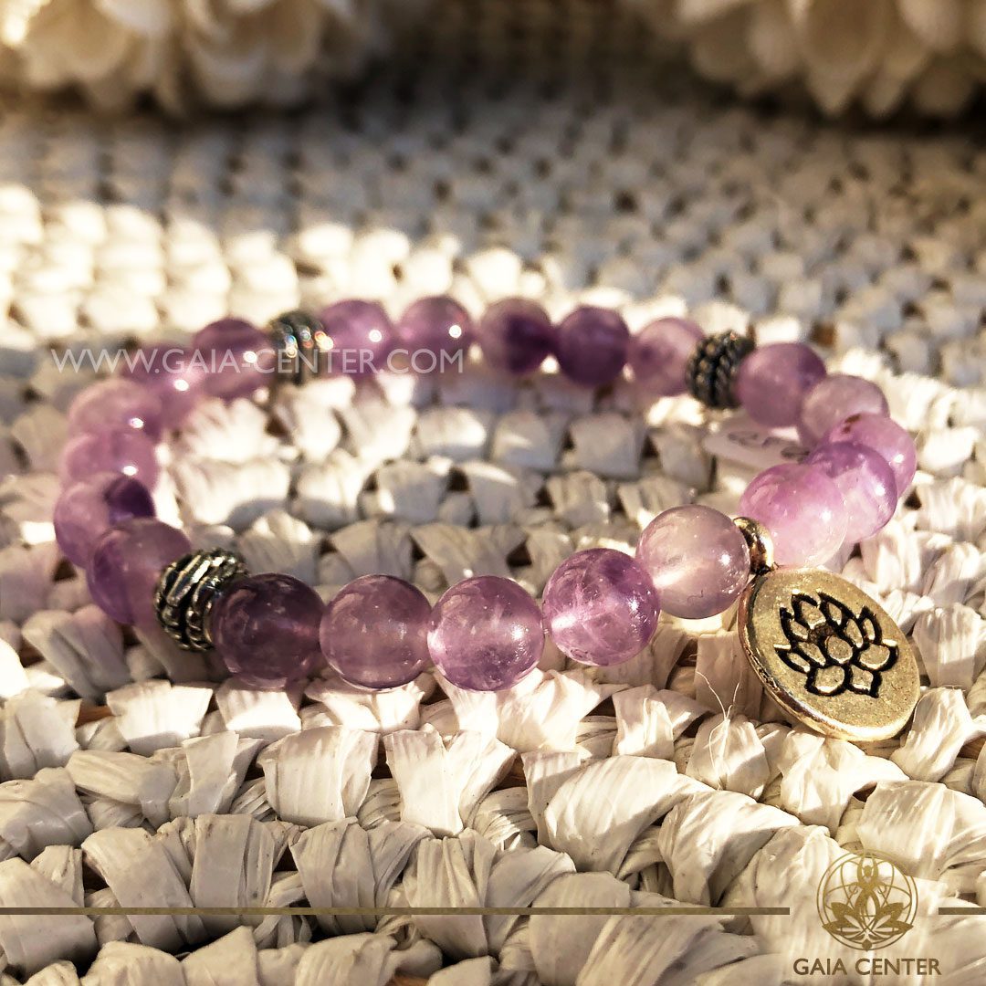 Crystal Mala Bracelet - 21 Amethyst quartz crystal beads with Lotus Flower symbol metal charm. Elastic string. Crystal and Gemstone Jewellery Selection at Gaia Center Crystal shop in Cyprus.