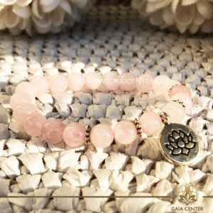 Crystal Mala Bracelet - 21 Rose quartz crystal beads with Lotus Flower symbol metal charm. Elastic string. Crystal and Gemstone Jewellery Selection at Gaia Center Crystal shop in Cyprus.