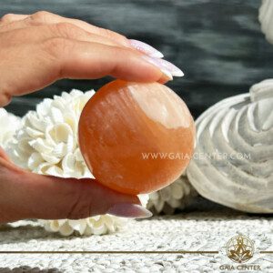 Orange Selenite Crystal Sphere |55mm| ball from Morocco at GAIA CENTER Crystal Shop CYPRUS. Crystal jewellery and crystal pendants at Gaia Center crystal shop in Cyprus. Order online top quality crystals, Cyprus islandwide delivery: Limassol, Larnaca, Paphos, Nicosia. Europe and Worldwide shipping.