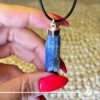 Blue Kyanite crystal pendant in a Rough shape with sterling silver setting from Brazil at Gaia Center Crystal shop in Cyprus. As you wear the Blue Kyanite Crystal Pendant, actively embrace its calming properties. It actively invites tranquility into your life, making it an ideal accessory for those seeking inner peace and balance amidst life's challenges. Order crystals online, Cyprus islandwide delivery: Limassol, Larnaca, Paphos, Nicosia. Europe and Worldwide shipping.